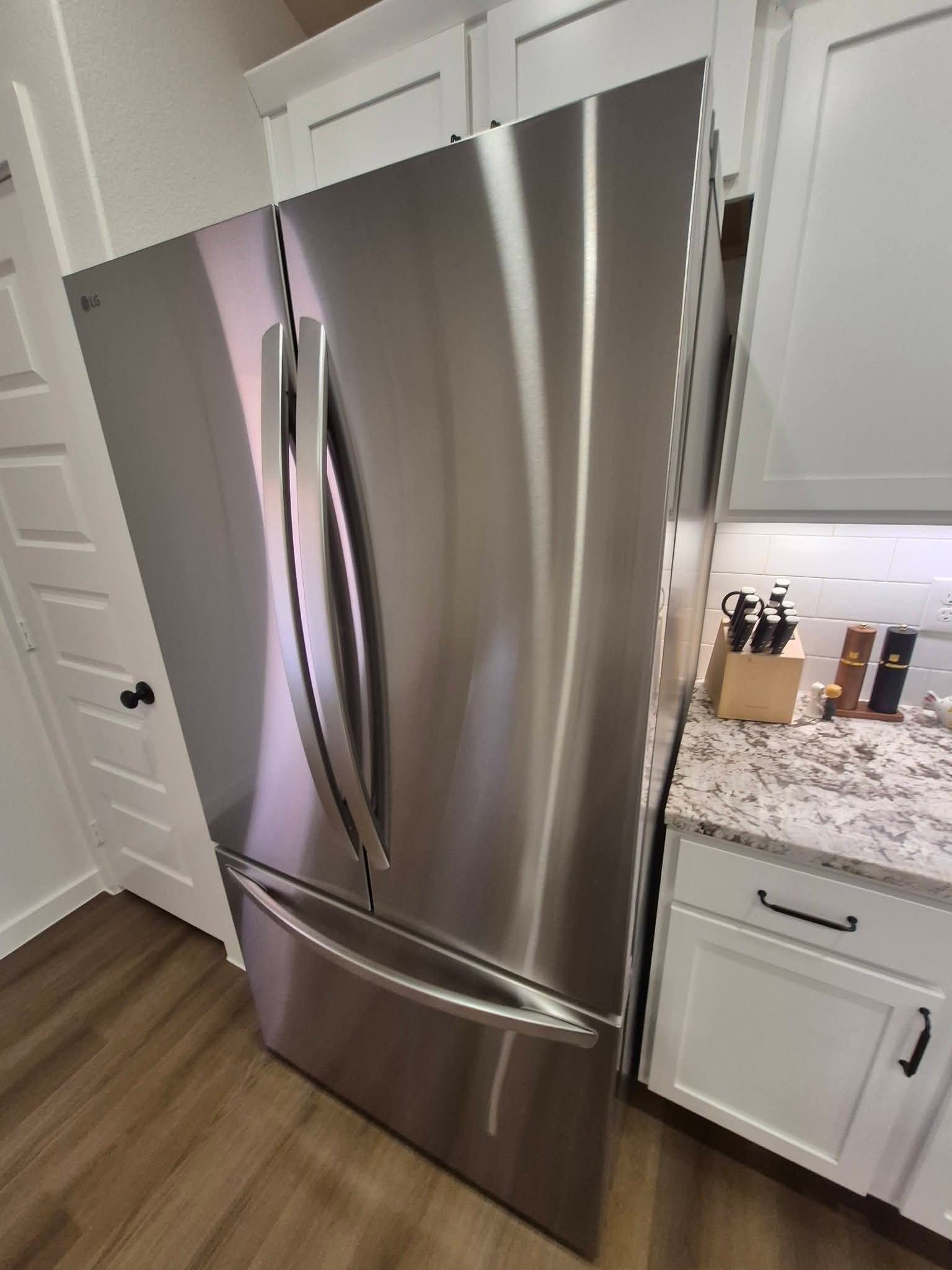 Gleaming stainless steel refrigerator in modern kitchen after professional cleaning