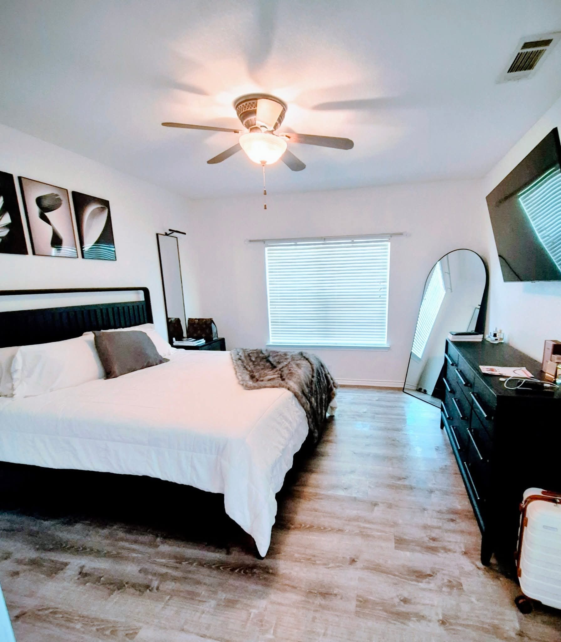 Freshly cleaned bedroom with ceiling fan and natural light