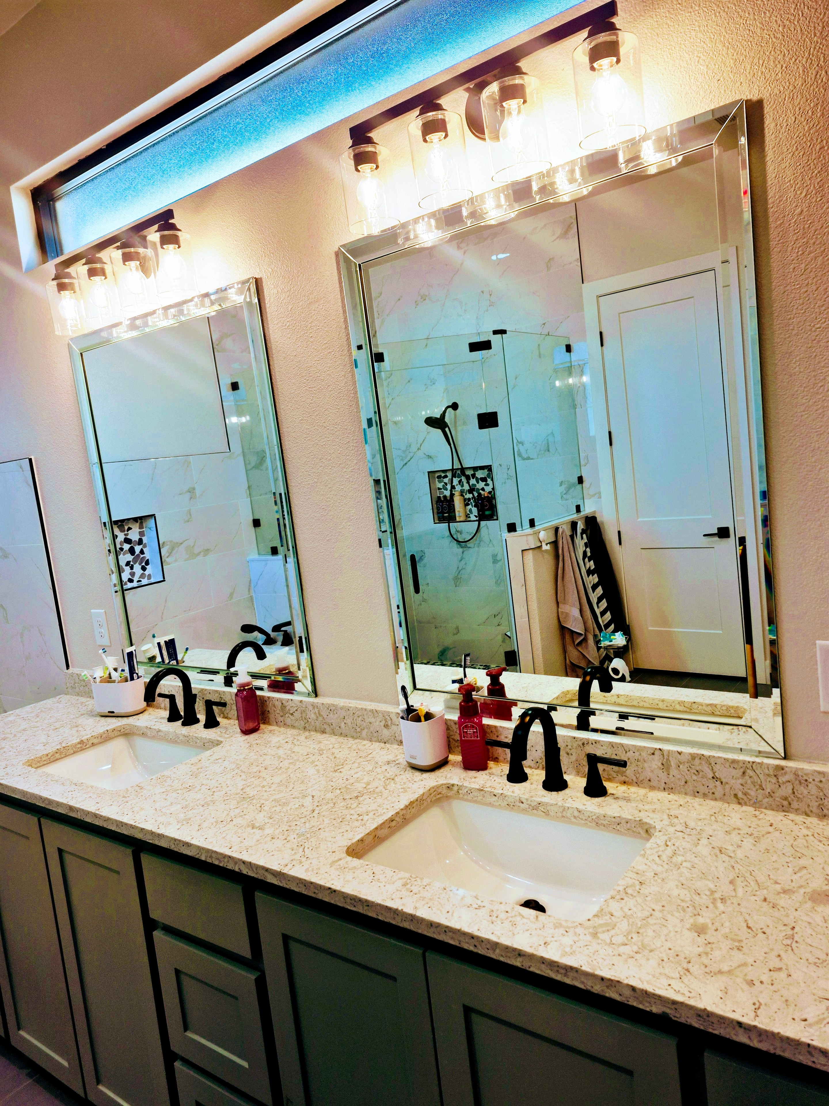 Spotless dual-sink bathroom vanity with mirrors after professional cleaning