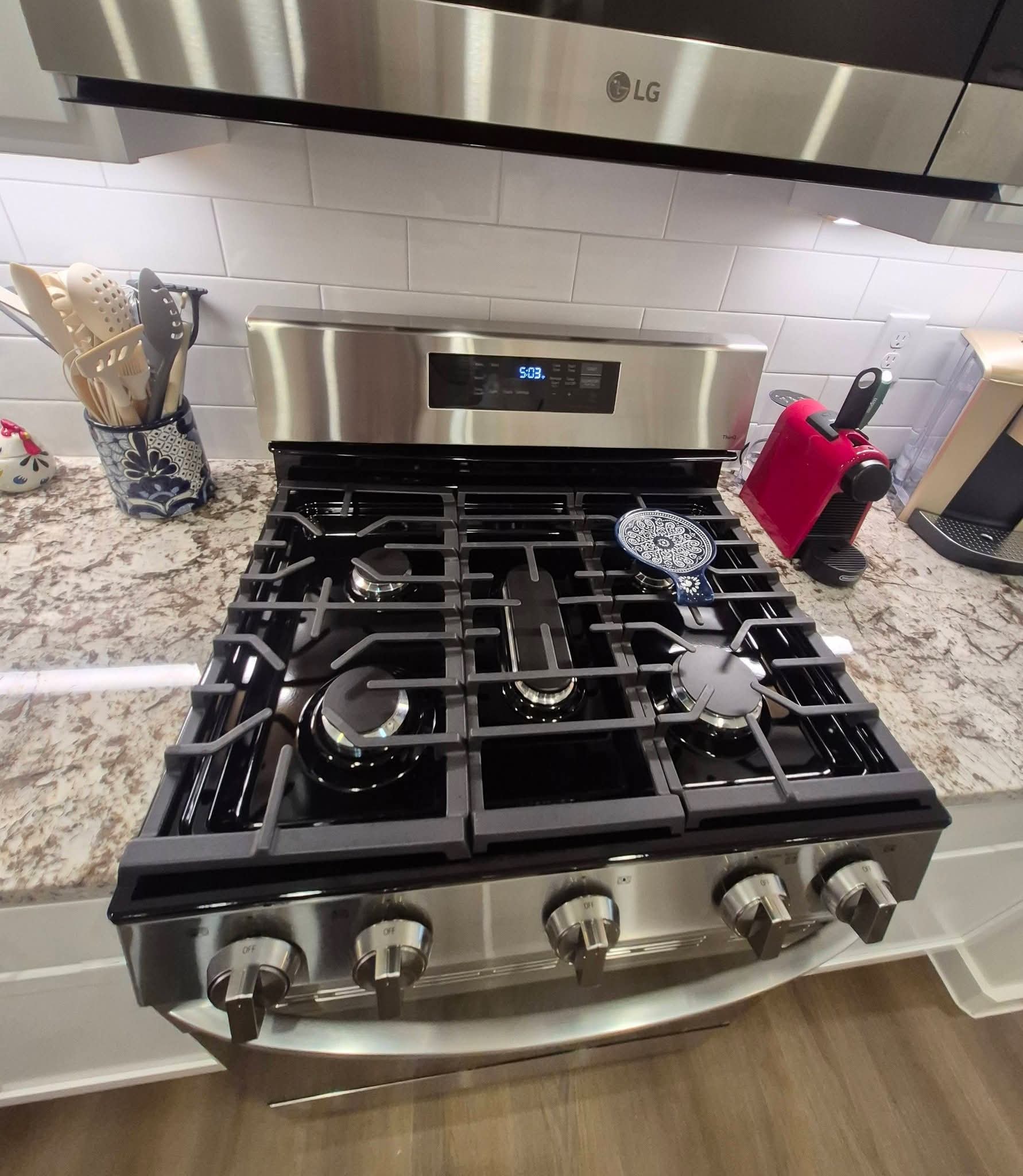 Spotless gas range with granite countertops after professional cleaning